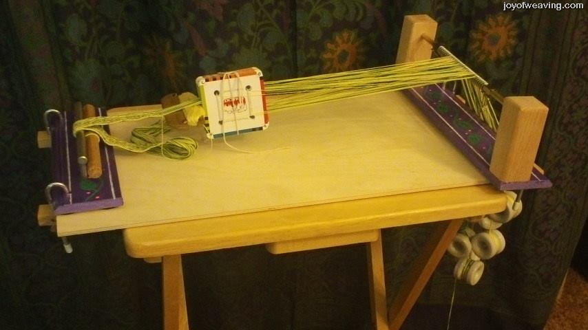 Easy DIY Tablet Weaving Loom clamped to a tv tray table.