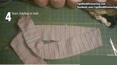 Start to fold the cloth in half.